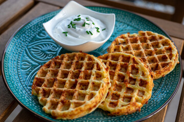 zucchini waffles gofri with sour cream dip on a plate