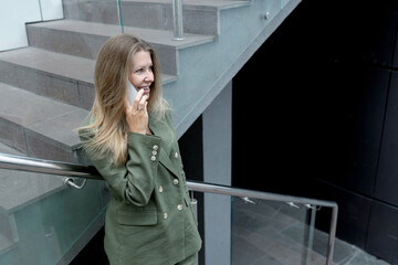 blonde woman in a suit doing business walking down the street