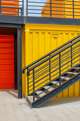 Black Ladder Against Yellow Wall Background