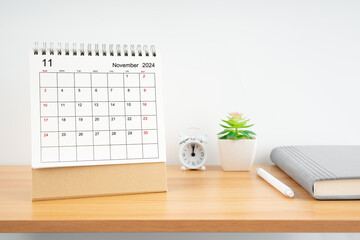 November 2024, Monthly desk calendar for 2024 year on wooden table.