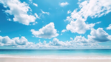 Obraz premium Tropical beach under a blue sky with white clouds. Perfect for a relaxing summer vacation.