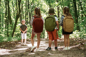 Little tourists. Kids in forest at summer daytime together