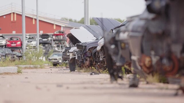 Rusty wrecks of retired vehicles dumped at scrapyard, low slider
