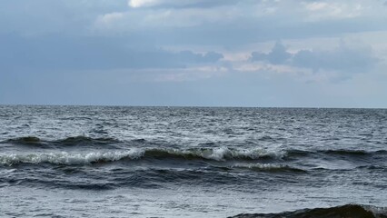 Waves of North sea and cloudy sky