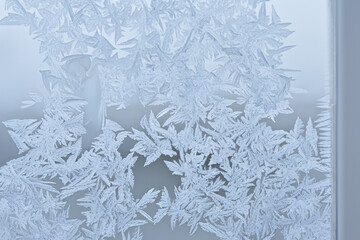 Frosted windows in the winter season. Crystal snow nature concept. Traces of frost on the glass of a window. Traces of frost on the glass in lifestyle the winter season.