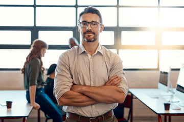 Portrait, manager and confident business man in coworking office for career pride. Face, arms crossed and leader, entrepreneur and creative web designer with glasses in startup for expert experience