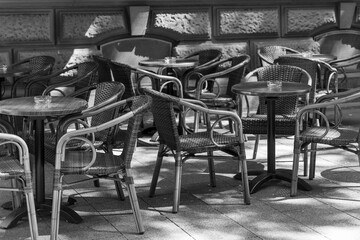 row of outdoor chairs and tables are set up in a restaurant