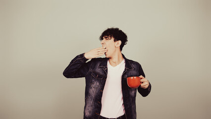 Early morning. A guy drinks hot coffee.