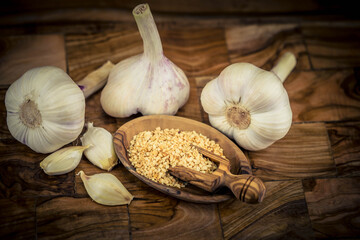 Frischer und getrockneter Knoblauch auf Olivenholz