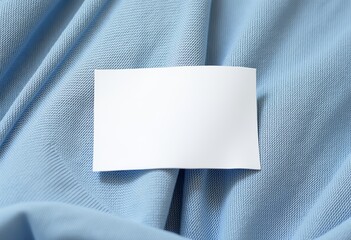 Fototapeta premium High-Resolution Stock Photo of a Blank Clothing Label Tag on Soft Wrinkled Shirt Fabric - Ideal for Mockup and Branding Designs.