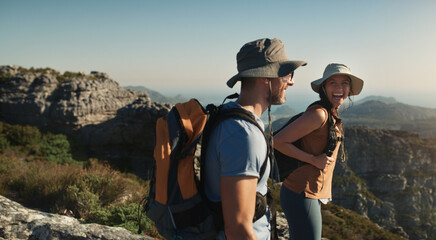 Couple, hiking and mountain on cliff outdoor for fitness travel, adventure view and backpack journey. People, backpacking and trekking together for cardio exercise, rock climbing and health in summer