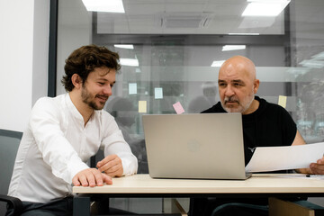 Fototapeta premium Employees participating in a brainstorming session in an office conference room. A perfect shot to illustrate a dynamic and creative work environment