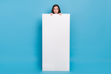 Full length photo of amazed funky lady hide over cellphone poster banner design nomad isolated blue...