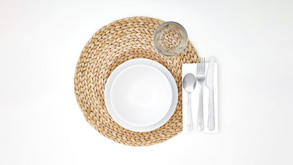 Top view closeup of cutlery on straw coaster.