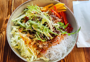 Salad with vegetables, rice noodles, sweet peppers, cucumbers, sauce and kutjut. Asian culture