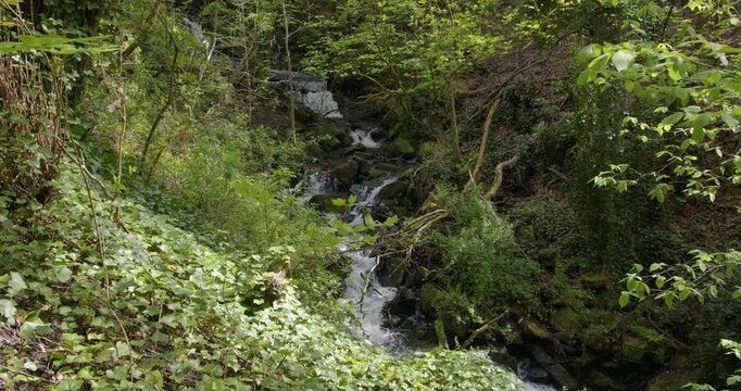 Extra wide shot of water cascading over waterfalls at Lumsdale waterfalls, Matlock