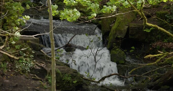 mid shot of water cascading over waterfalls at Lumsdale waterfalls, Matlock