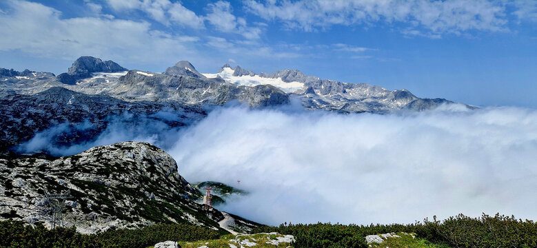 Part of white cloud sleep in Dachsteingletscher mountains, June 28, 2022.