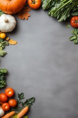 Top view of fresh autumn vegetables on a grey background, perfect for seasonal food and harvest-themed visuals.