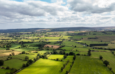 Fototapeta premium Aerial drone photo of the beautiful town of Leyburn which is a market town and civil parish in North Yorkshire in the UK, showing the houses in the town from above in the summer time