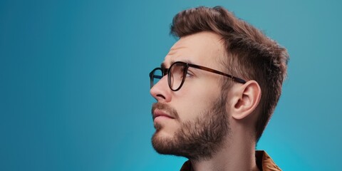Fototapeta premium This is a portrait of a young man wearing glasses and smiling. He has modern style, with casual attire, and appears friendly and approachable.