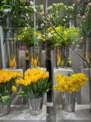 Beautiful green yellow and white flowers in the fridge of a flower shop, fore sale, vertical image 