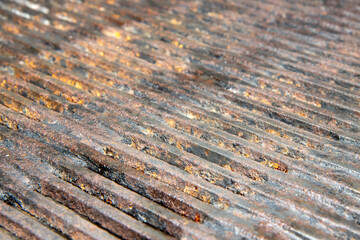 A close up of a dirty rusty metal barbecue grill