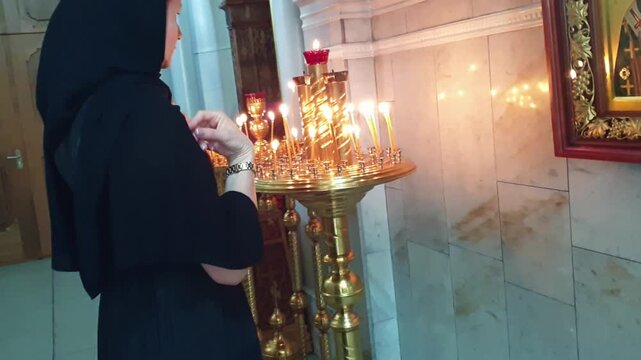 Slow motion footage of the woman praying in the orthodox church. Religion