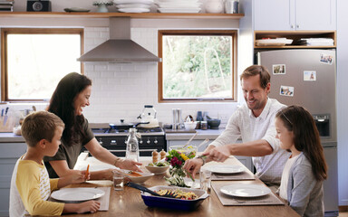 Parents, children and eating together at table with nutrition for lunch, love and bonding in kitchen. Mother, father and kids with healthy food in family home for brunch, vegan diet and relationship