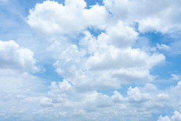 Bright blue sky with fluffy white clouds on a sunny summer day