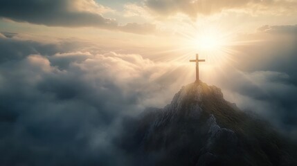 Cross on Mountain Peak at Sunset