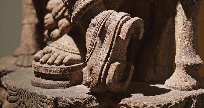 Close-up view on foot of Statue Of Krishna Playing Flute. He Is God Of Protection, Compassion, Tenderness, And Love. Krishna Is Major Deity In Hinduism