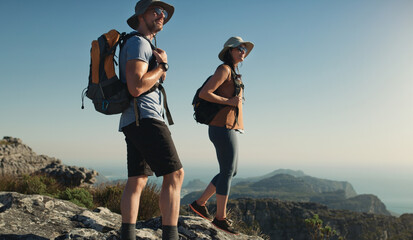 Mountain, journey and man with woman on peak for adventure in nature, landscape and travel. Outdoor...