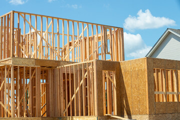plywood house frame against blue sky