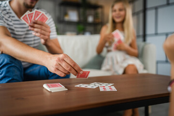 close up of men hand put a card on the table