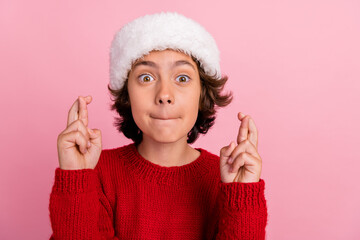 Photo of kid boy cross fingers pleading on christmas eve isolated pastel color background