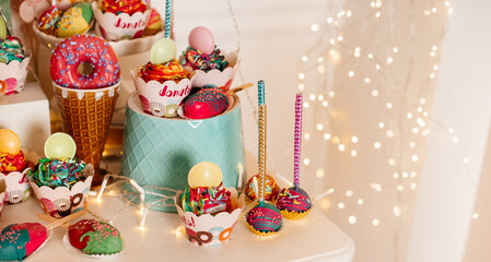 Vibrant party table setup with colorful sweets and decorations, ideal for festive events.