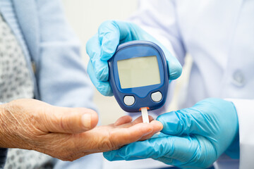 Doctor use digital glucose monitor measure and test stripe for check diabetes from finger blood sugar level.