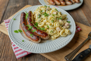 Traditional german Bratwurst with homemade pasta salad. Delicious rustic food