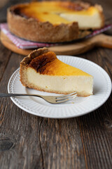 Slice of rustic sour cream cake on wooden table