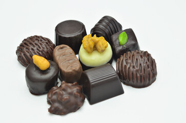 Different kinds of chocolate pralines, close up, isolated on white background