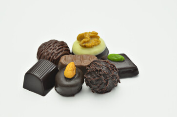 Different kinds of chocolate pralines, close up, isolated on white background