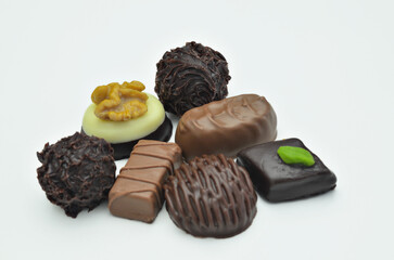 Different kinds of chocolate pralines, close up, isolated on white background