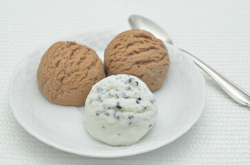 Chocolate ice cream and vanilla ice cream on white plate