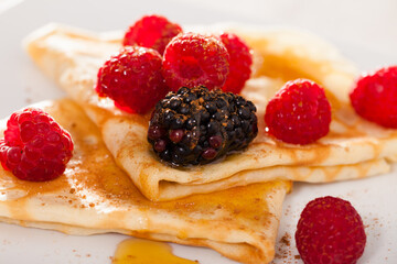 Pancakes with raspberries, blackberries and honey