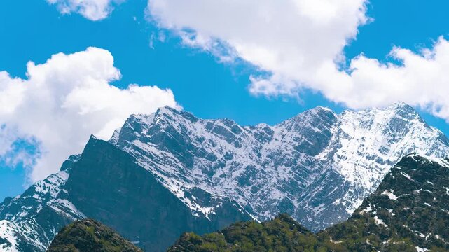 4K Timelapse of clouds moving in blue sky over snow covered Himalaya mountains in Jispa at lahaul, Himachal Pradesh, India. Nature landscape. Summer season clouds and mountains time lapse. 