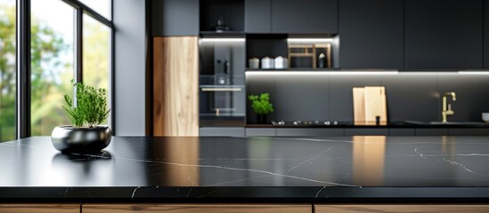 Black marble kitchen countertop with black cabinets and dark tiles in the background