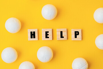 A yellow background with a large group of white balls scattered around it