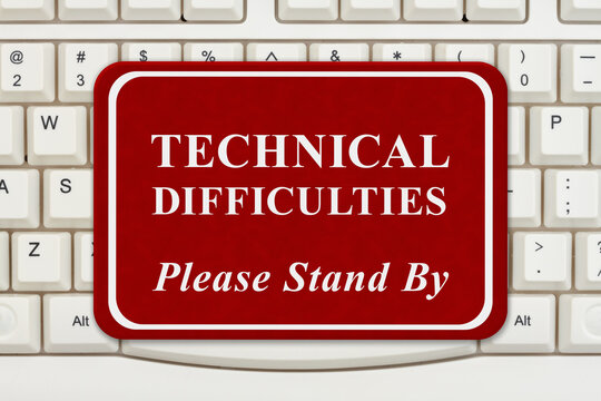  Technical Difficulties sign on keyboard
