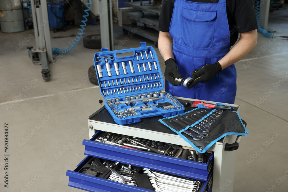 Wall mural auto mechanic with different tools at automobile repair shop, closeup